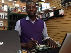 Mandoye Ndiaye runs Afrik PC, a computer repair shop.