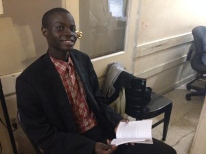 Cheikh Lo with his recently published book.